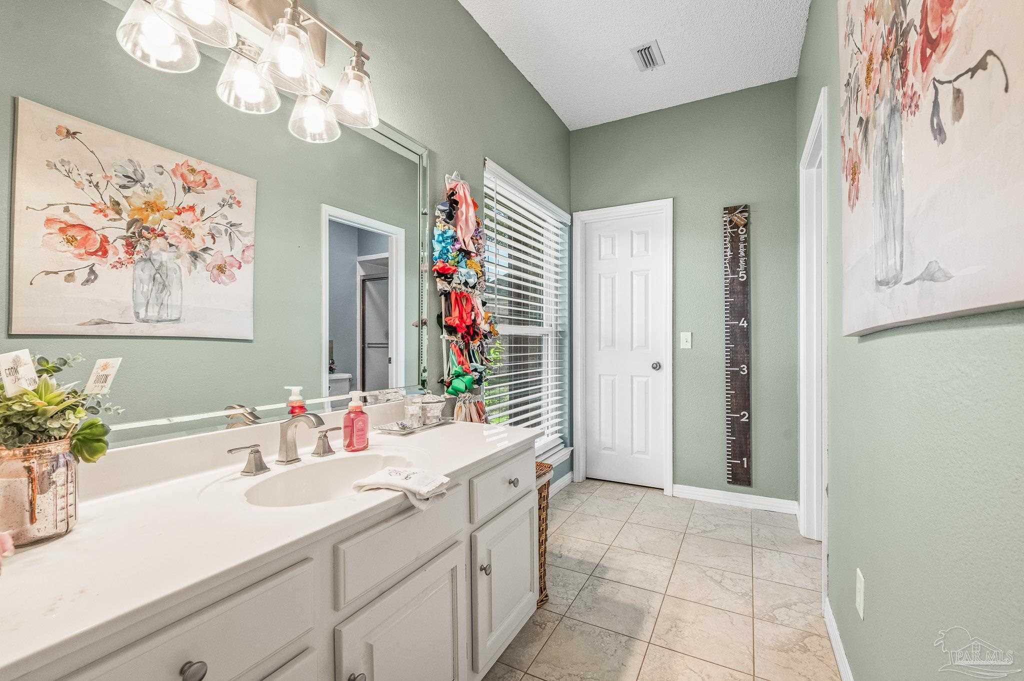 10443 Tam O Shanter Road Pensacola, FL 32514 - Photo 42 of 57 a bathroom with a sink a large mirror and a shower