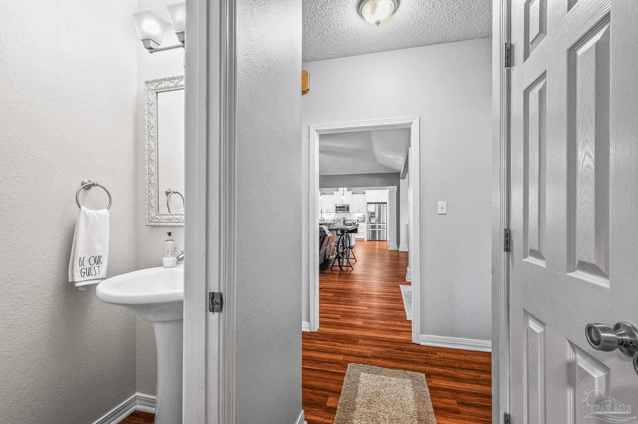 10443 Tam O Shanter Road Pensacola, FL 32514 - Photo 47 of 57 a view of a hallway with wooden floor and a bathroom