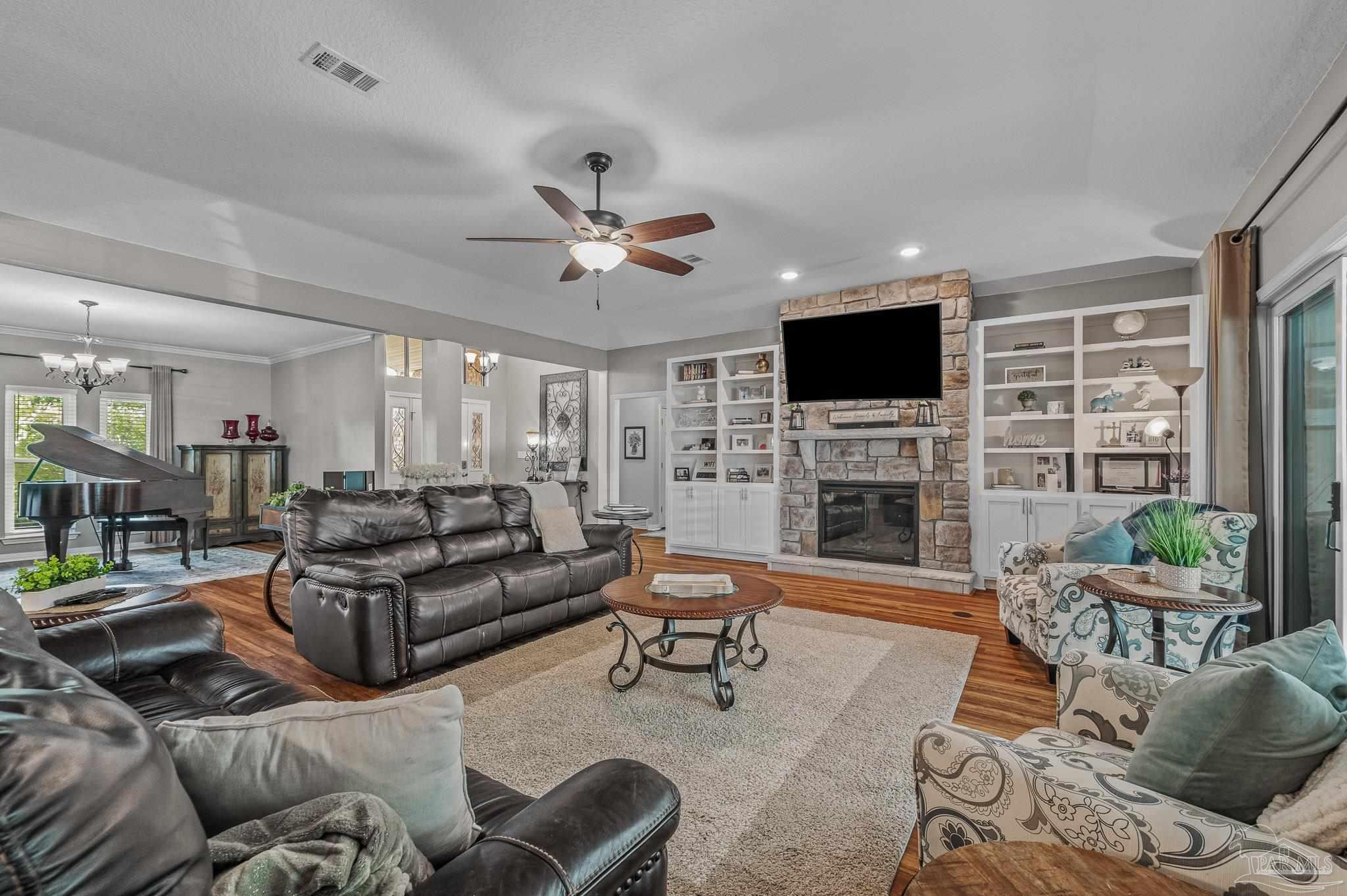 10443 Tam O Shanter Road Pensacola, FL 32514 - Photo 7 of 57 a living room with furniture a fireplace and a flat screen tv