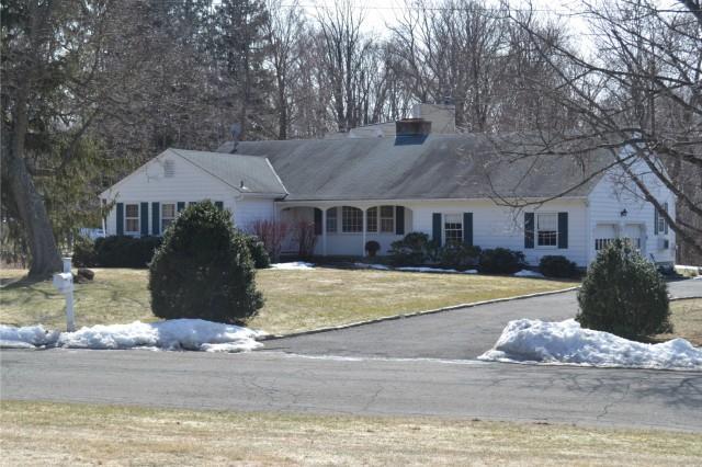 58 Old Studio Road New Canaan, CT 06840 - Photo 1 of 1 a front view of a house with a yard and garage