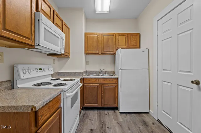 a view of a hallway with wooden floor and a window