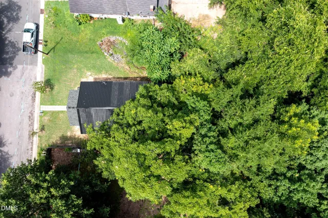 an aerial view of a house with a yard