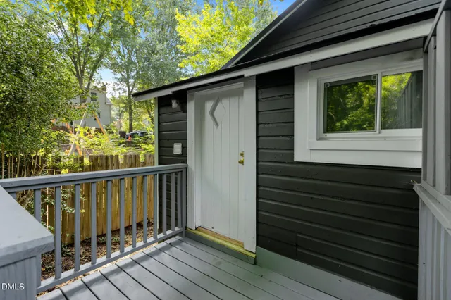 a view of a yard with plants and tree