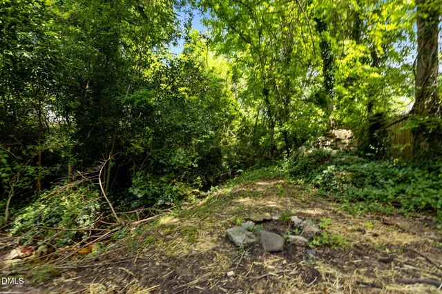 a view of a house with a large window and wooden deck