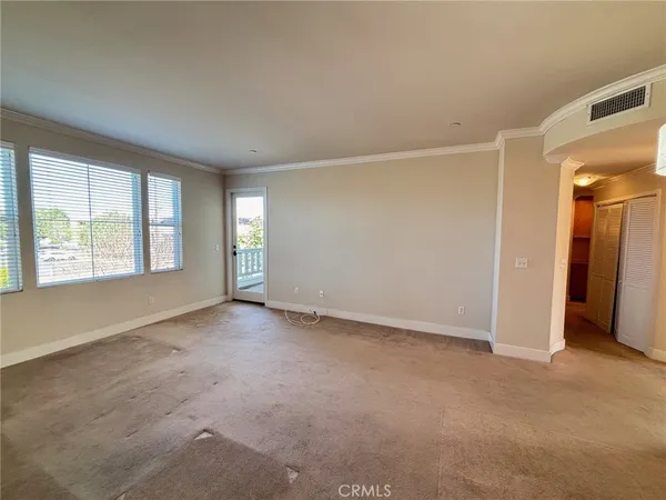 an empty room with windows and closet