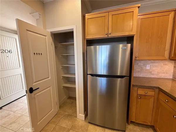 a view of a kitchen with a refrigerator and a sink