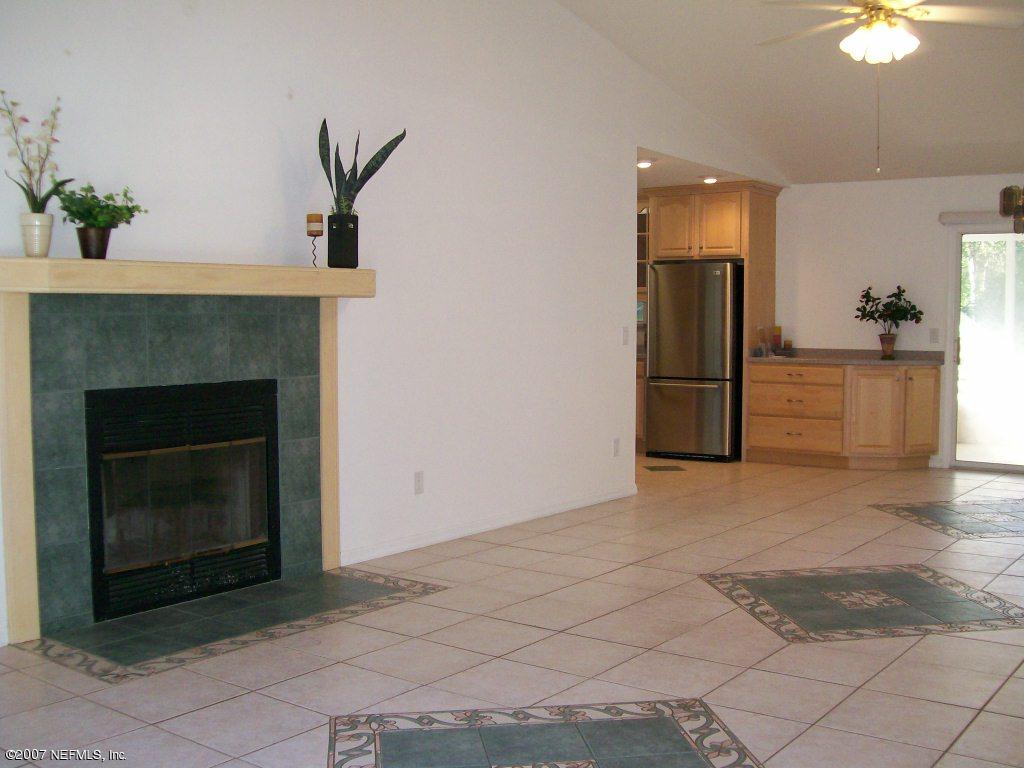 3333 Carmel Road St. Augustine, FL 32086 - Photo 9 of 12 a view of a livingroom with a fireplace and a chandelier fan