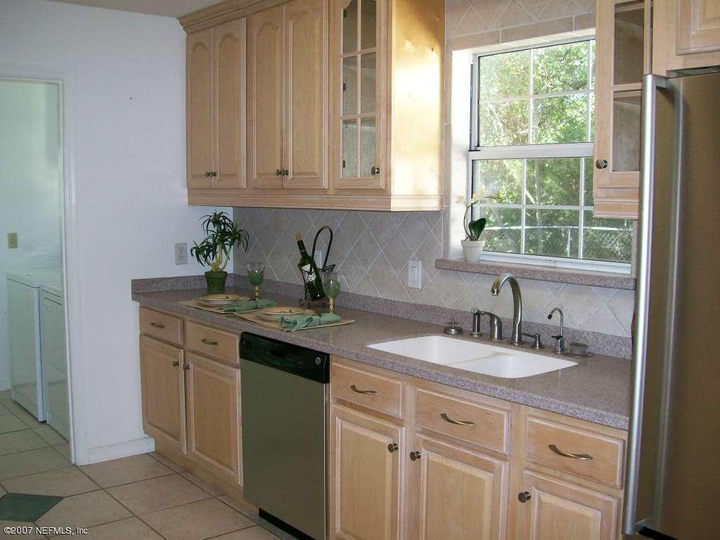 3333 Carmel Road St. Augustine, FL 32086 - Photo 10 of 12 a sink with granite countertop white cabinets and a sink