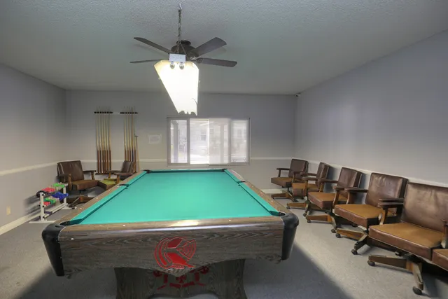 a room with pool tables and windows