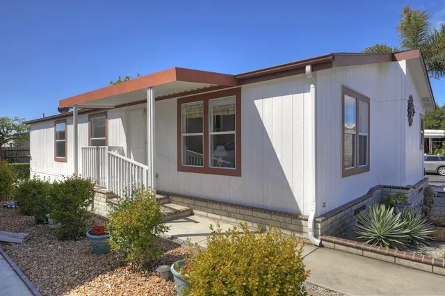 a front view of house and yard with green space