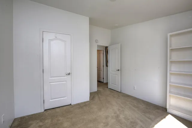 a view of an empty room and closet area
