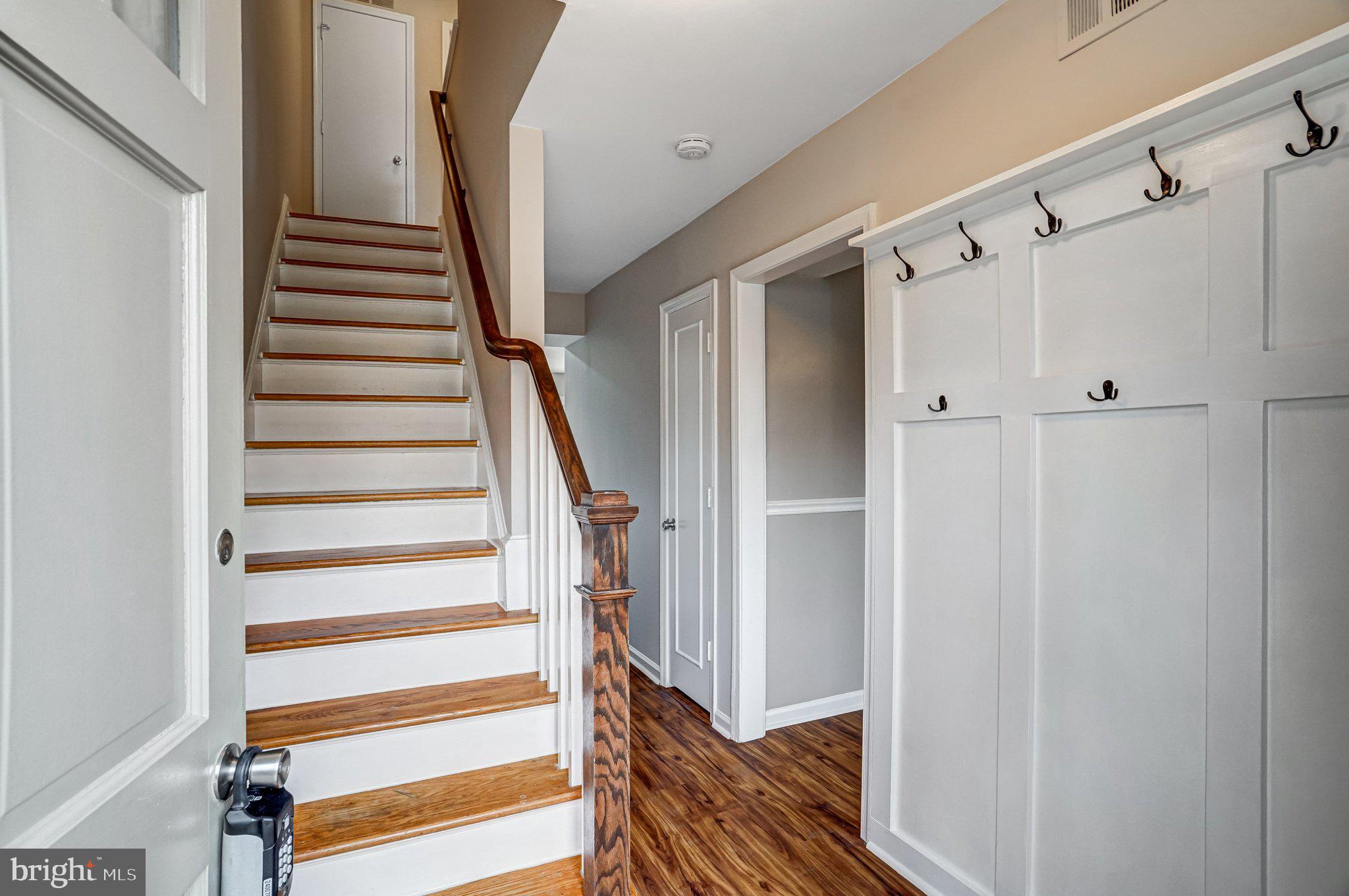 8396 Forrester Boulevard, Unit 555 Springfield, VA 22152 - Photo 3 of 24 a view of entryway with wooden floor and stairs