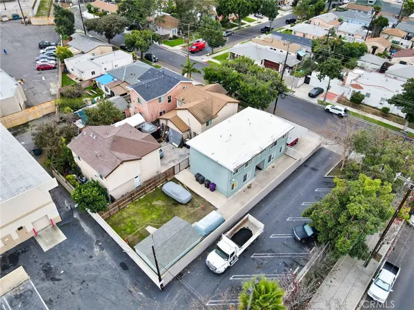 an aerial view of a residential houses with yard