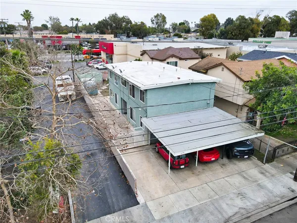 an aerial view of a houses with a yard
