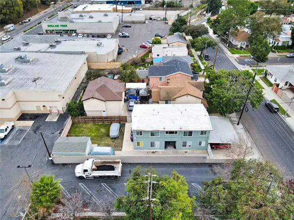 an aerial view of a house with garden space and street view