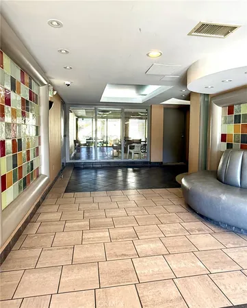 a lobby with furniture and a rug