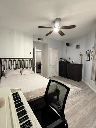 a bedroom with furniture and wooden floor