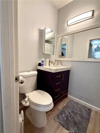 a bathroom with a toilet a sink and mirror