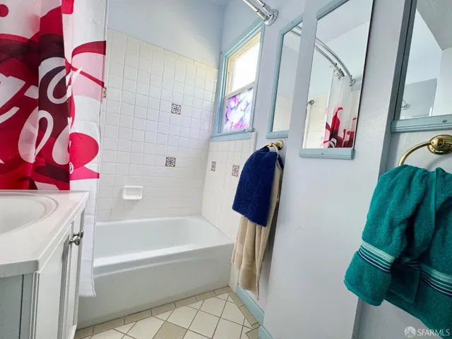 a bathroom with a tub sink and a shower