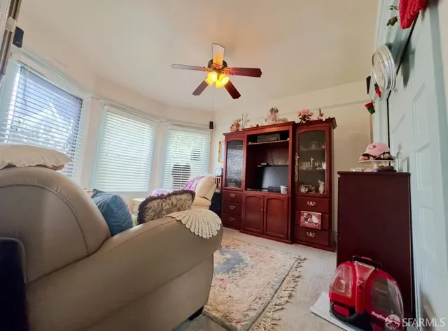 a living room with furniture a rug and a window