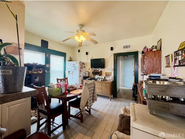 a view of a dining room with furniture and a kitchen