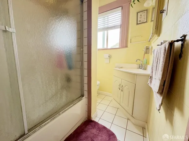 a bathroom with a bathtub sink and mirror