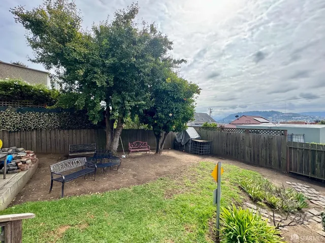 a view of a backyard with sitting area