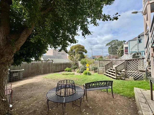 a view of a chairs and table in backyard