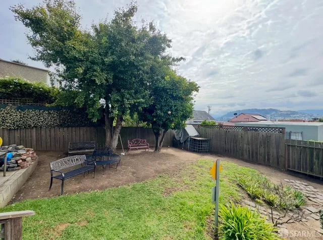 a view of a backyard with sitting area