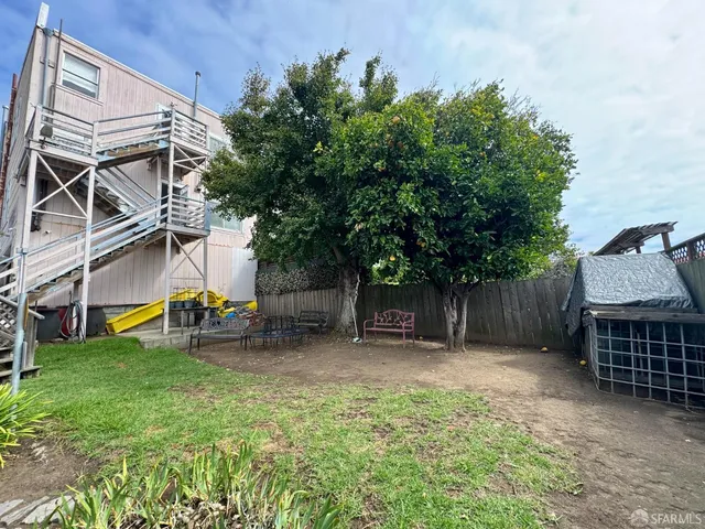 a view of a backyard with a table and chairs