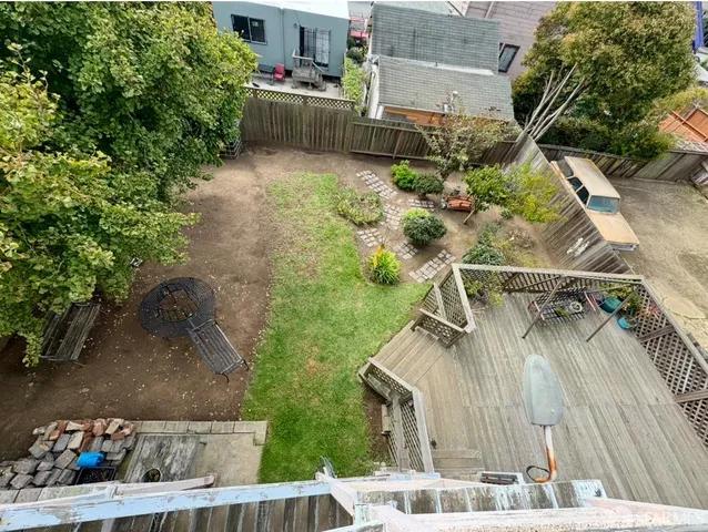 a balcony with chairs and a potted plant