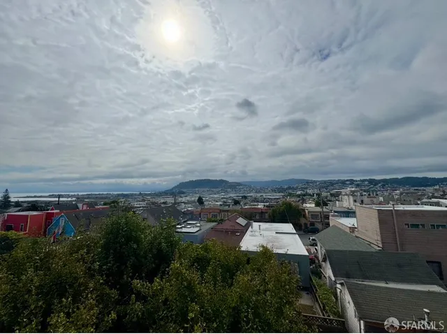 an aerial view of residential building and car parked