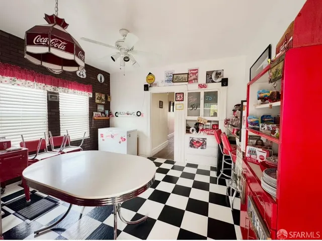 a room with furniture a rug and white walls
