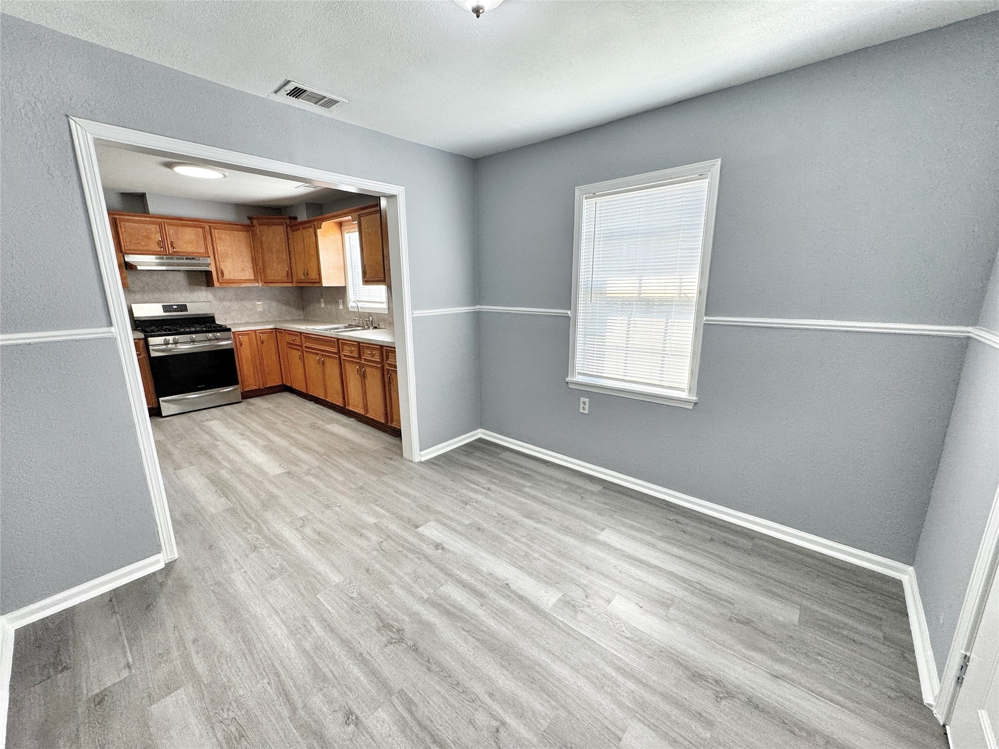 2633 Hollis Street Houston, TX 77093 - Photo 13 of 32 a kitchen with granite countertop a refrigerator and a stove