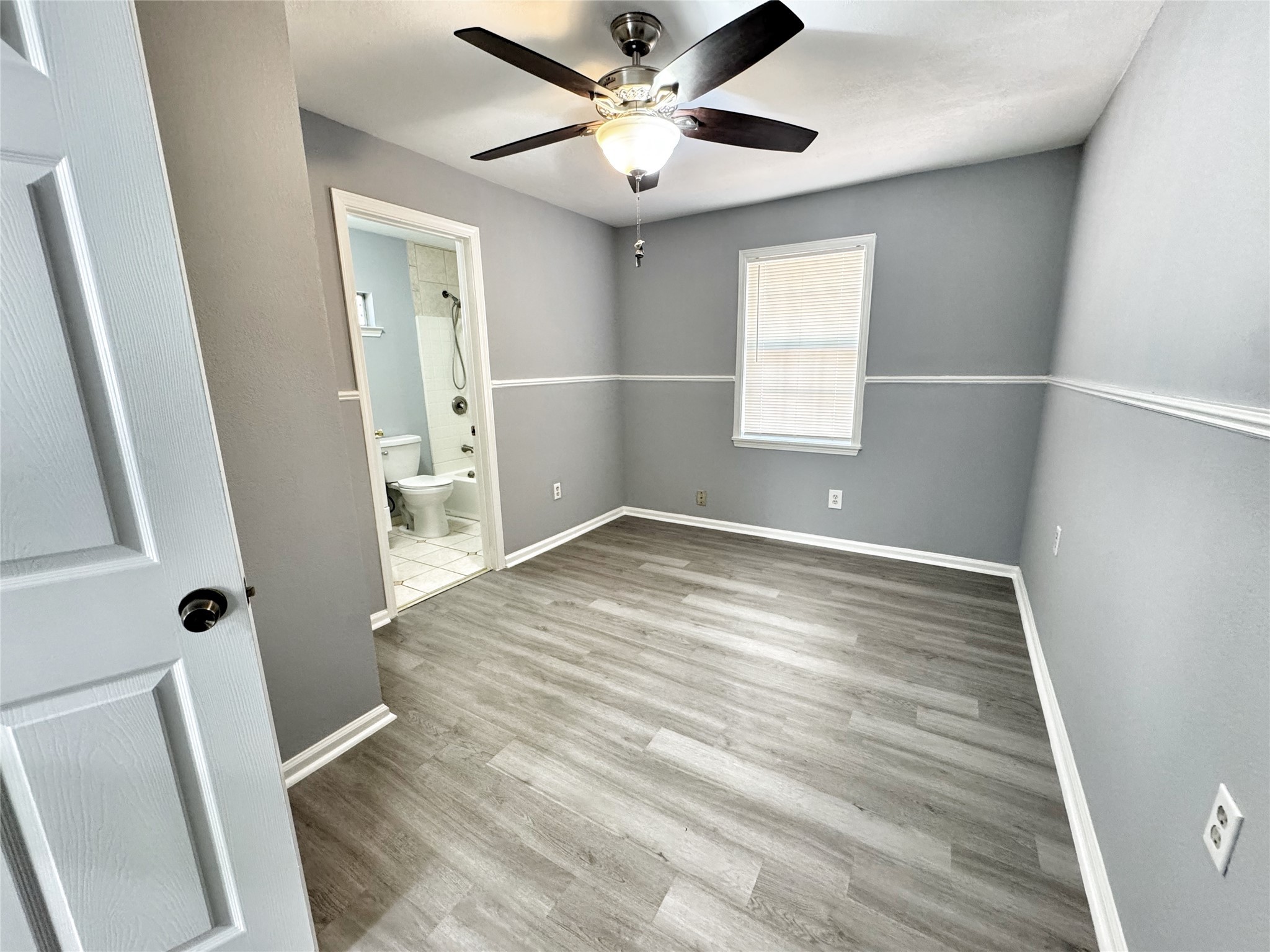 2633 Hollis Street Houston, TX 77093 - Photo 14 of 32 wooden floor in an empty room with a window
