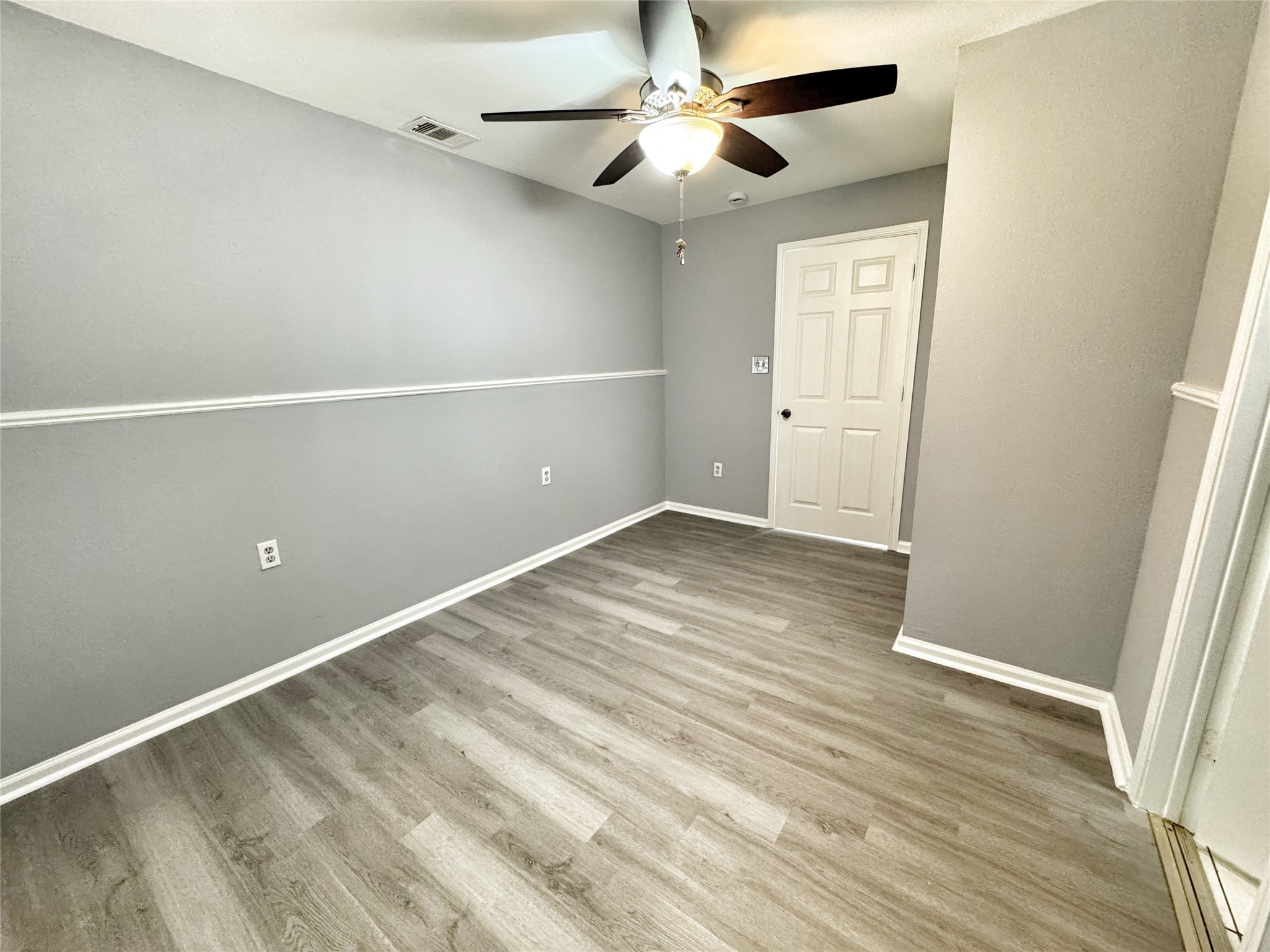 2633 Hollis Street Houston, TX 77093 - Photo 15 of 32 an empty room with wooden floor fan and windows