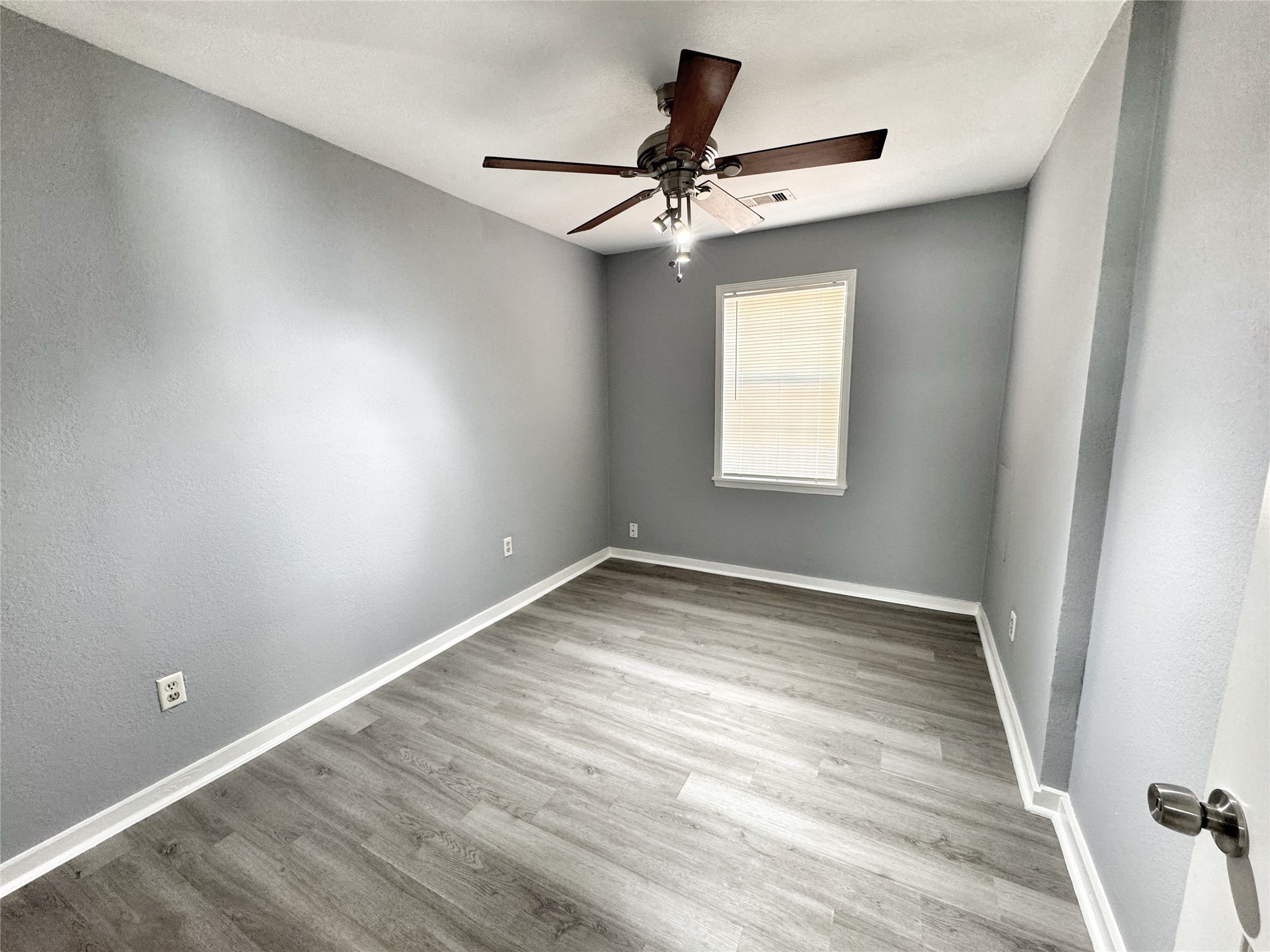 2633 Hollis Street Houston, TX 77093 - Photo 20 of 32 a view of empty room with wooden floor and fan