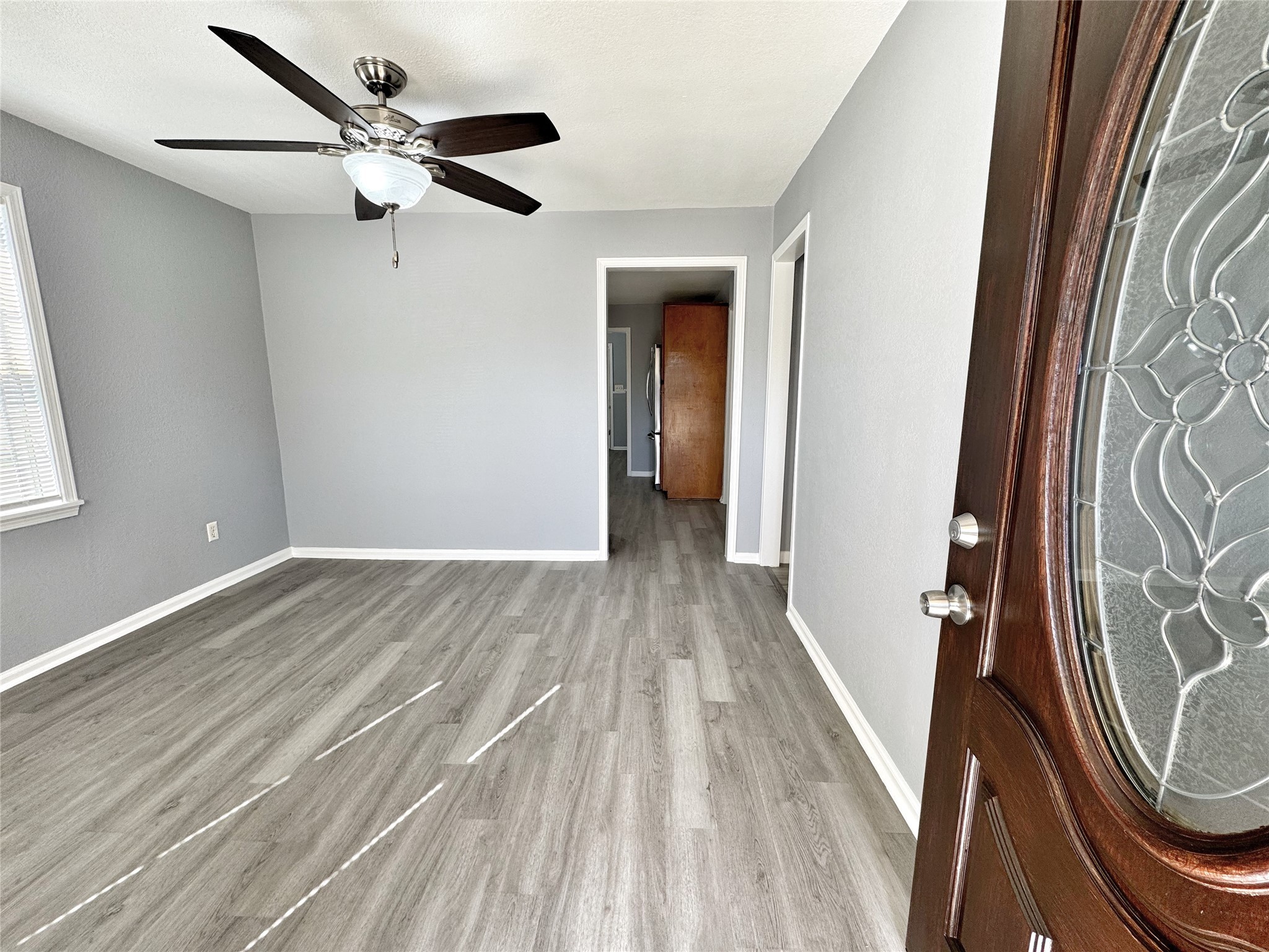 2633 Hollis Street Houston, TX 77093 - Photo 4 of 32 wooden floor in an empty room with a window