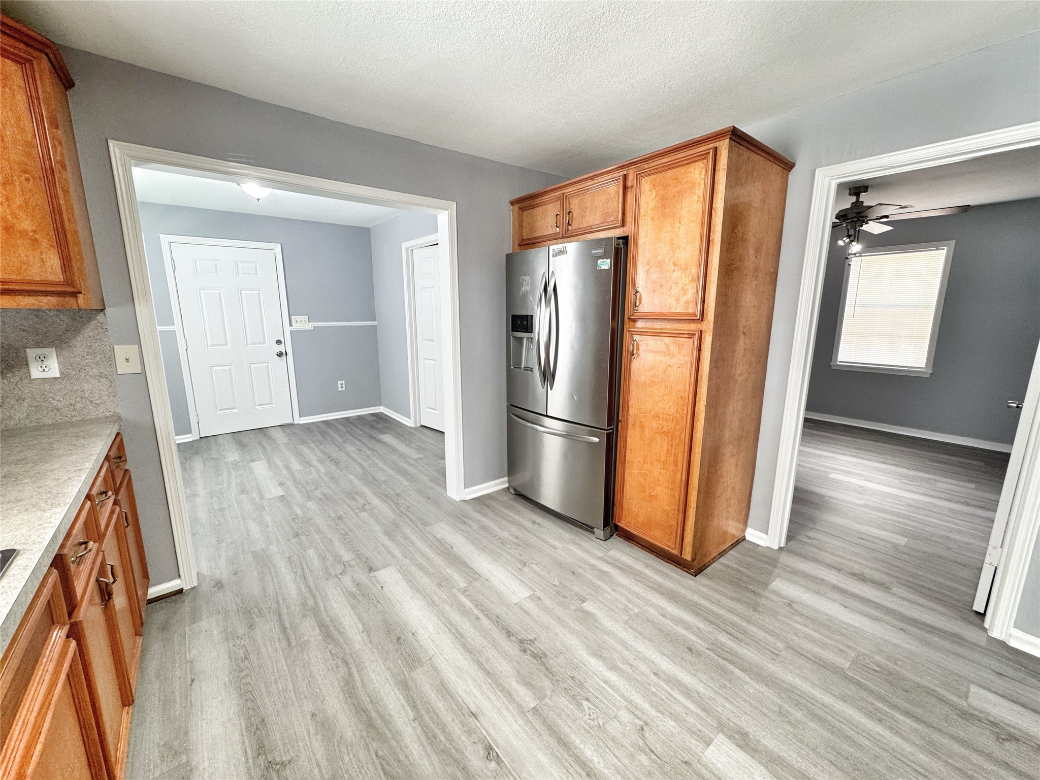 2633 Hollis Street Houston, TX 77093 - Photo 9 of 32 a view of a kitchen with wooden floor and a refrigerator