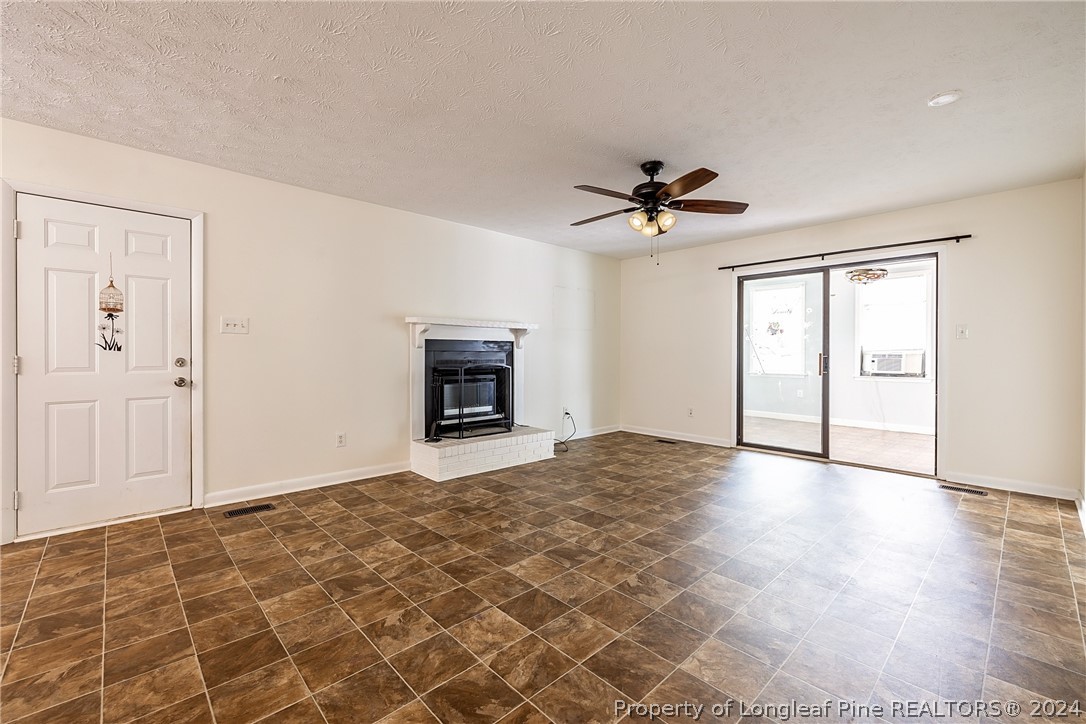 101 Dundee Lane Spring Lake, NC 28390 - Photo 5 of 32 an empty room with fan and a ceiling fan