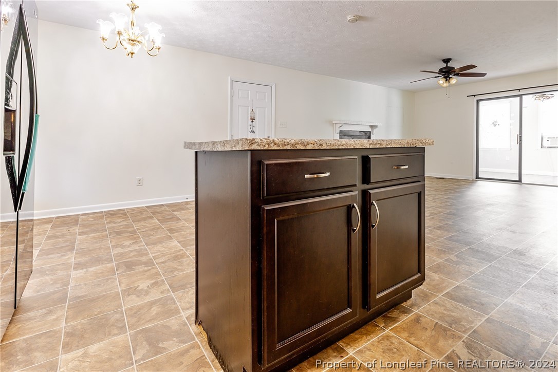 101 Dundee Lane Spring Lake, NC 28390 - Photo 10 of 32 a kitchen with granite countertop a sink cabinets and stainless steel appliances