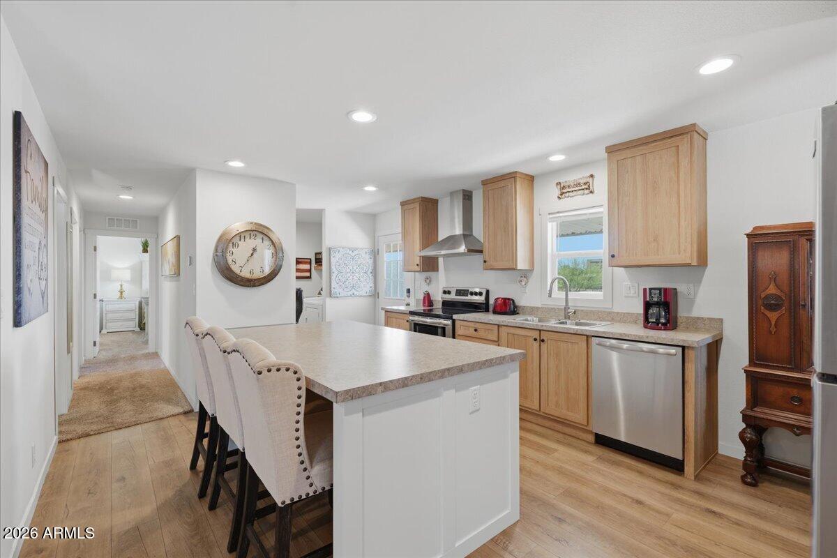 320 East McKellips Road, Unit 199 Mesa, AZ 85201 - Photo 14 of 32 a kitchen with kitchen island granite countertop a sink a stove refrigerator and cabinets