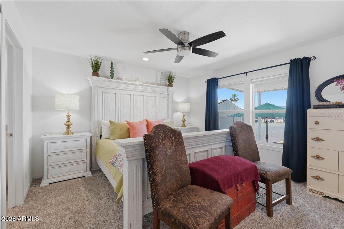 320 East McKellips Road, Unit 199 Mesa, AZ 85201 - Photo 19 of 32 a living room with furniture a ceiling fan and a window