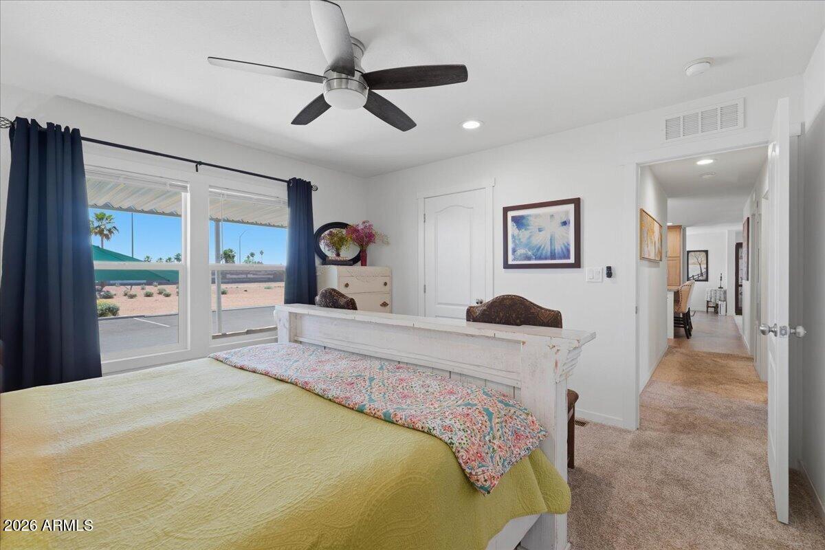 320 East McKellips Road, Unit 199 Mesa, AZ 85201 - Photo 20 of 32 a bedroom with a bed and a large mirror