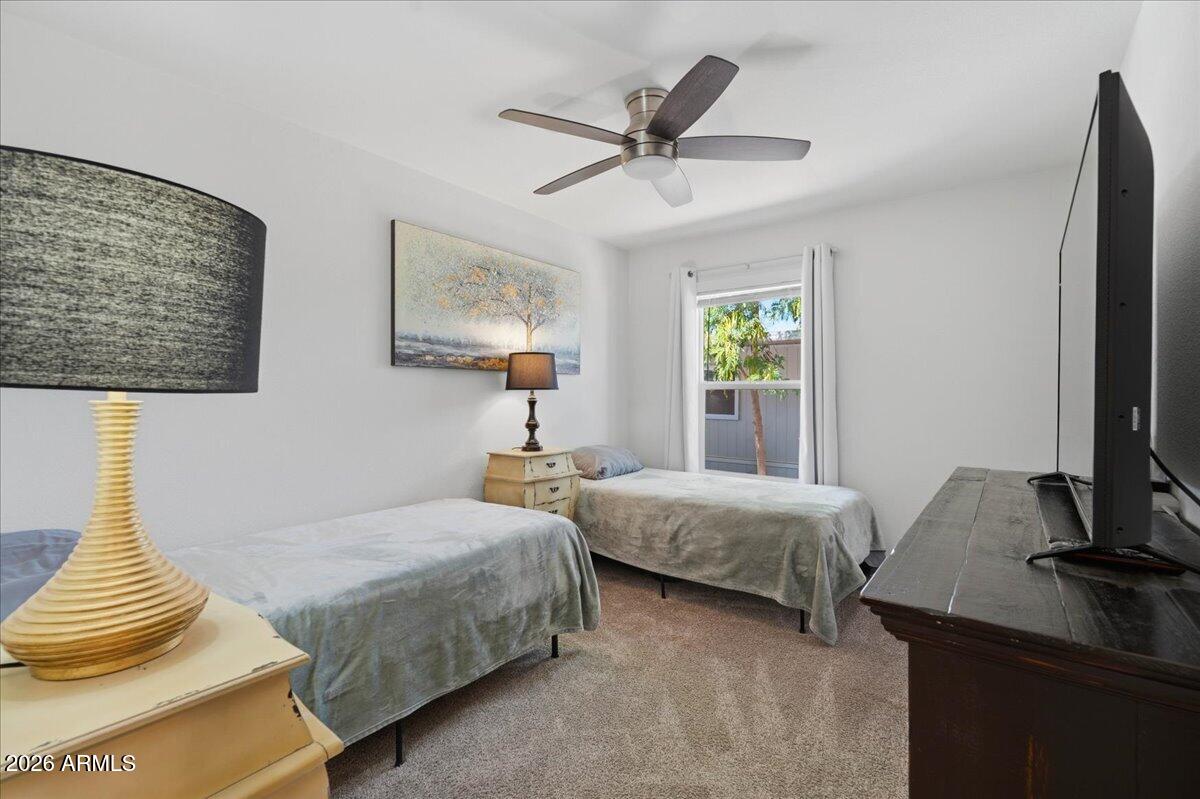 320 East McKellips Road, Unit 199 Mesa, AZ 85201 - Photo 24 of 32 a bedroom with a bed and a window