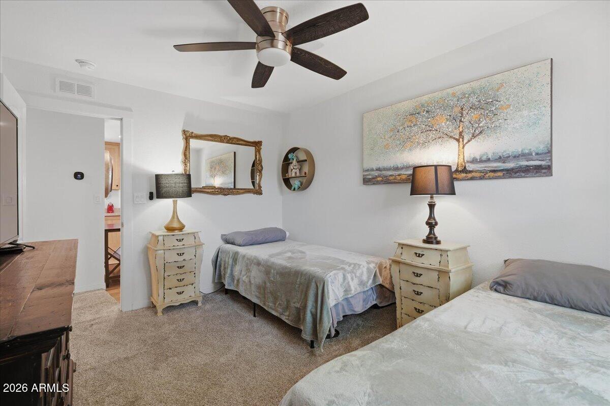 320 East McKellips Road, Unit 199 Mesa, AZ 85201 - Photo 25 of 32 a bedroom with two beds and painting on the wall