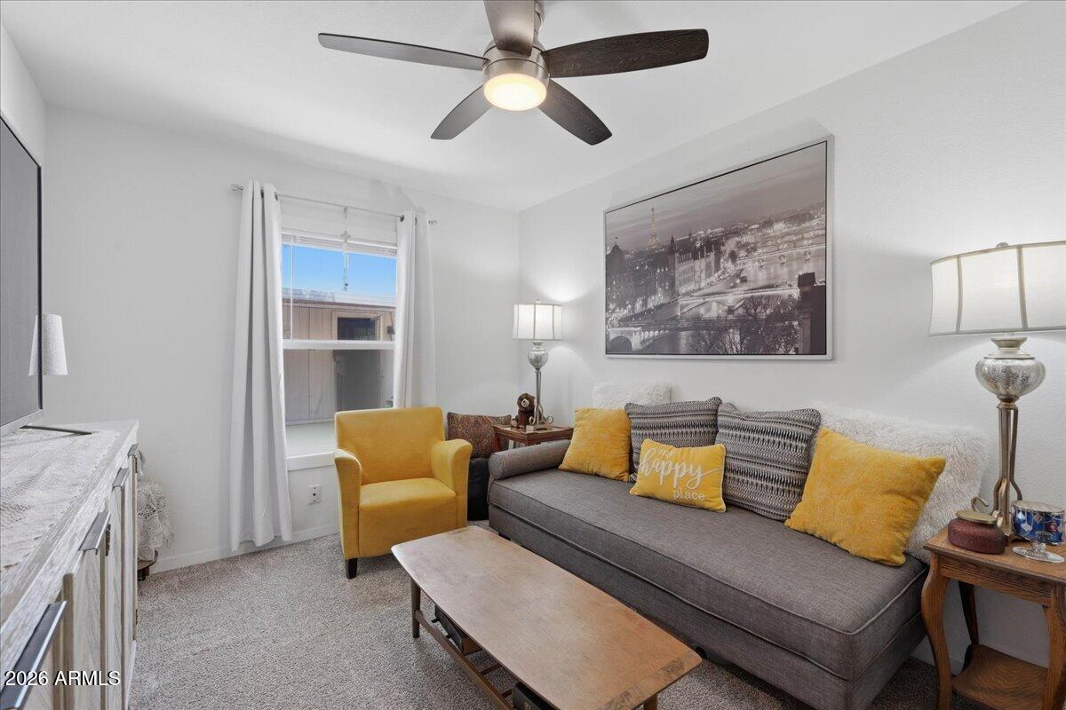 320 East McKellips Road, Unit 199 Mesa, AZ 85201 - Photo 27 of 32 a living room with furniture and a chandelier