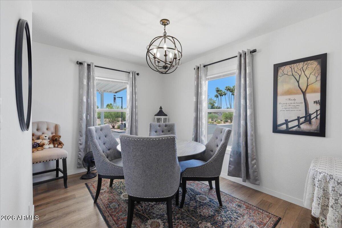 320 East McKellips Road, Unit 199 Mesa, AZ 85201 - Photo 3 of 32 a view of a dining room with furniture window and wooden floor