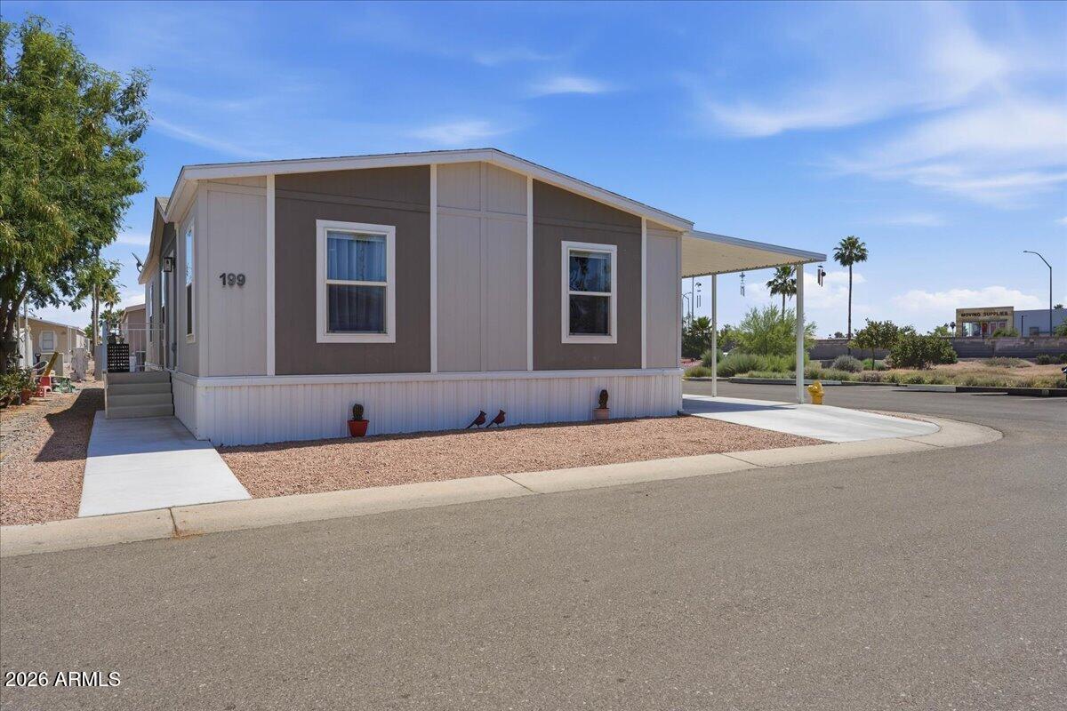 320 East McKellips Road, Unit 199 Mesa, AZ 85201 - Photo 5 of 32 a front view of a house with a yard