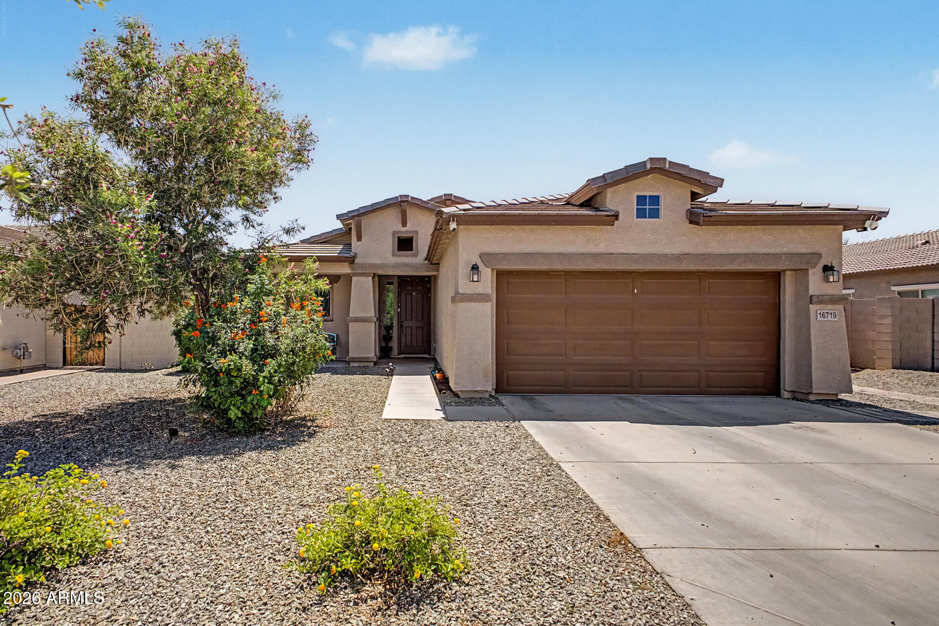 16719 West Rowel Road Surprise, AZ 85387 - Photo 27 of 28 a front view of a house with a yard and garage